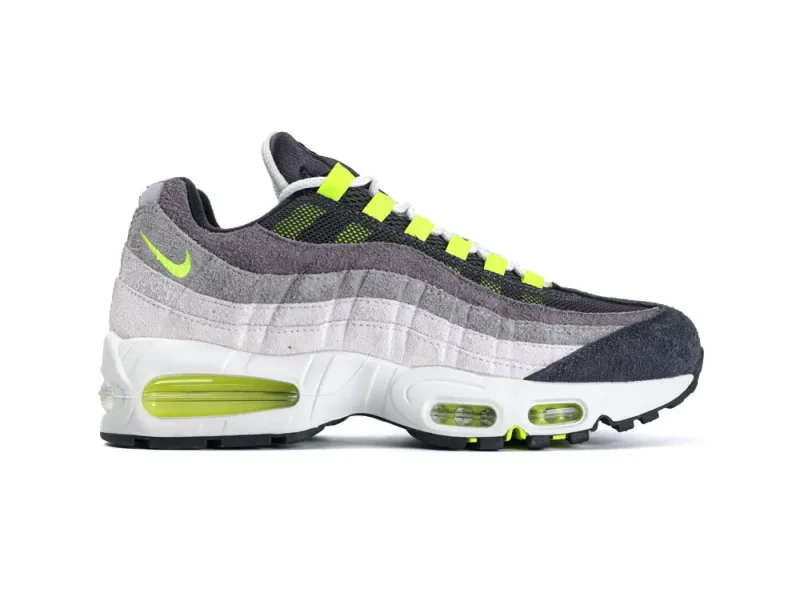 Gray and neon green sneaker with suede material and visible air cushioning.