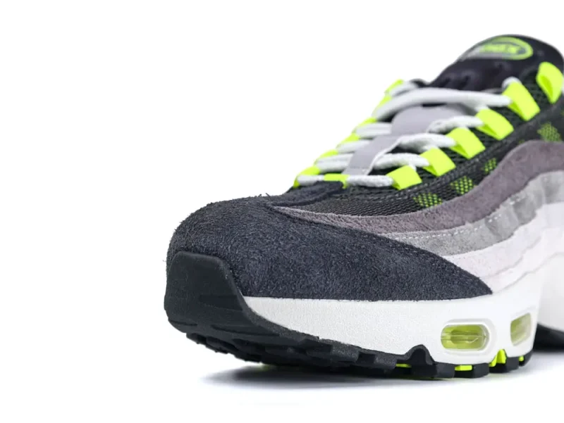 Gray and black suede sneaker with neon yellow accents and white sole.