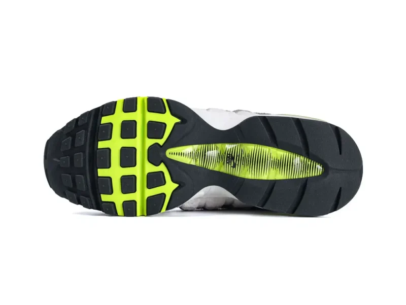 Black and neon green rubber sneaker sole with grid pattern design.