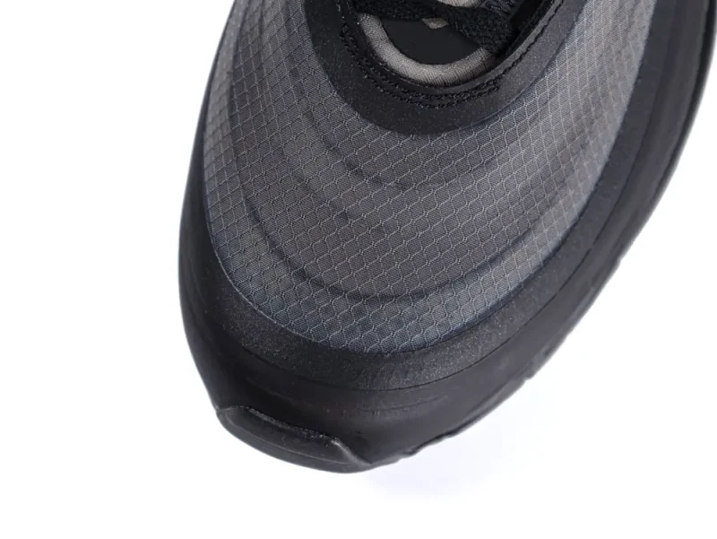 Close-up of a gray mesh sneaker toe with black rubber trim.