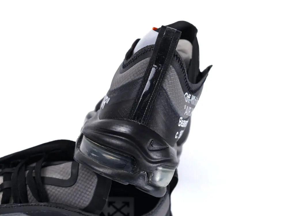 Black mesh sneaker with a transparent Air Max sole and printed white text.