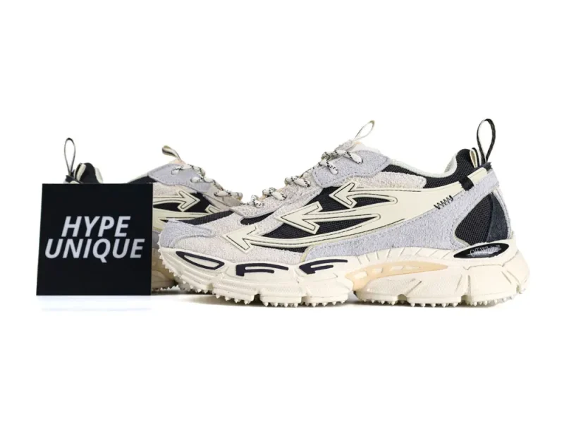 Gray and beige sneakers with fabric upper, rubber sole, and black details. Hype Unique.