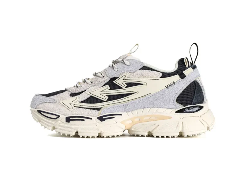 Gray and cream sneaker with suede and mesh materials, featuring a thick, textured sole.