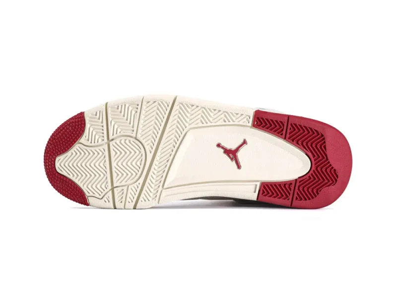 Red and white rubber sneaker sole with textured grip pattern and logo detail.