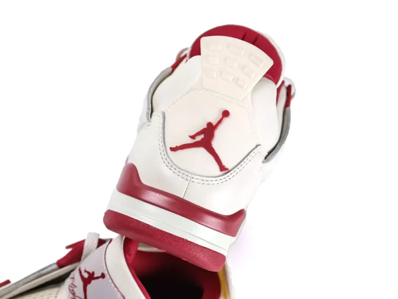 White and red leather sneaker heel with embossed logo and rubber outsole.