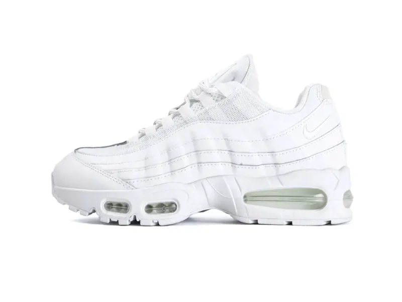 All-white sneaker with mesh and leather materials, featuring visible air cushioning in sole.