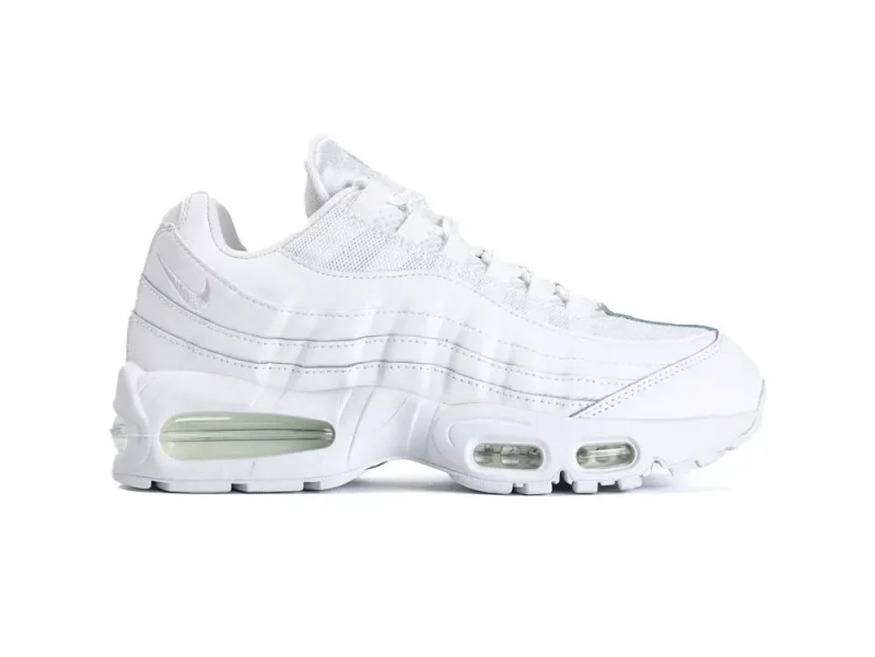White sneaker with mesh and leather upper, visible air cushioning in the sole.