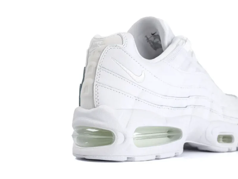 White leather sneaker with visible air cushioning and stitched detailing on the side.