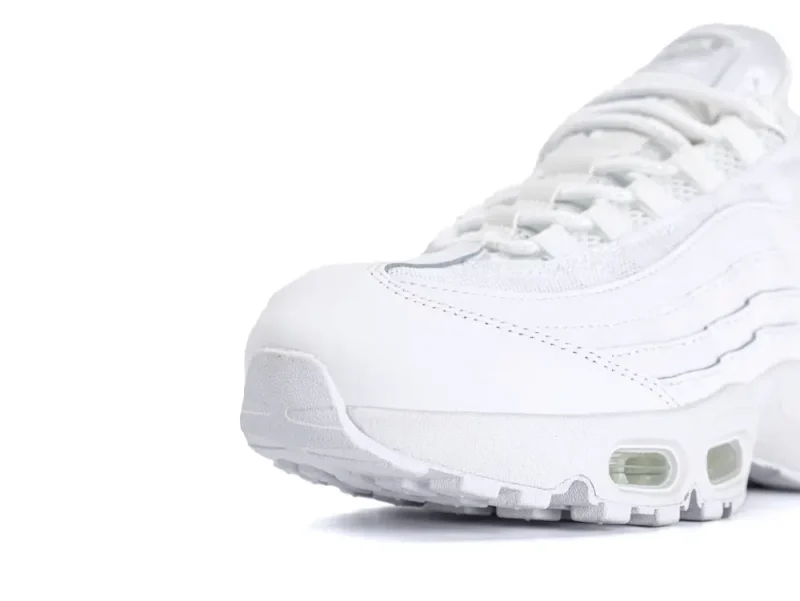 White leather and mesh sneaker with visible air cushioning and textured sole.