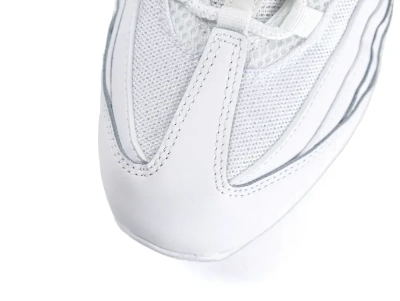 White leather and mesh sneaker toe detail with stitching.