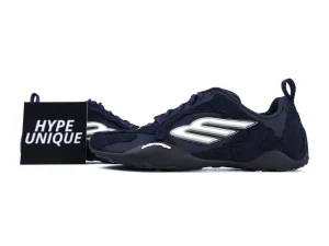 Dark blue sneakers with fabric upper, silver logo, and black rubber sole.