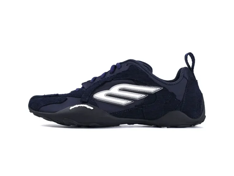 Navy blue sneaker with a textured fabric upper and a decorative silver logo.
