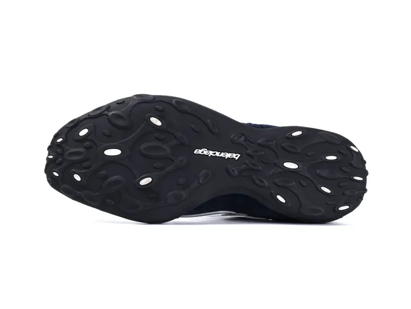 Black rubber shoe sole with textured design and manufacturer's logo in white.