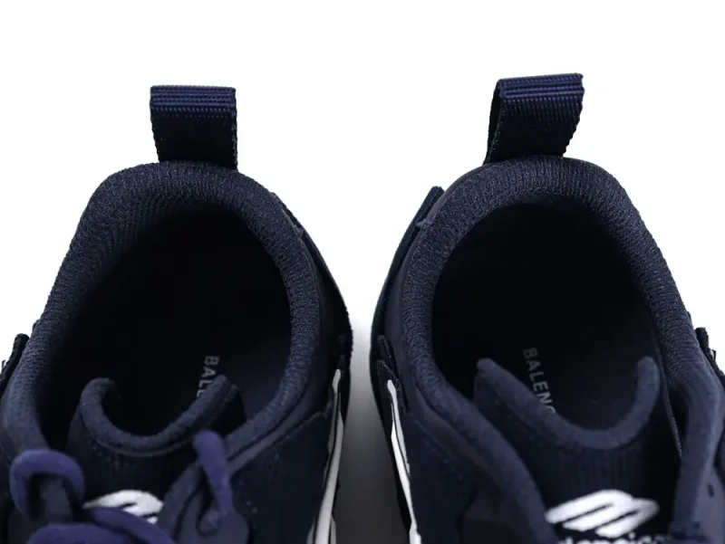Dark navy fabric sneakers with white accents, showing top view of openings.