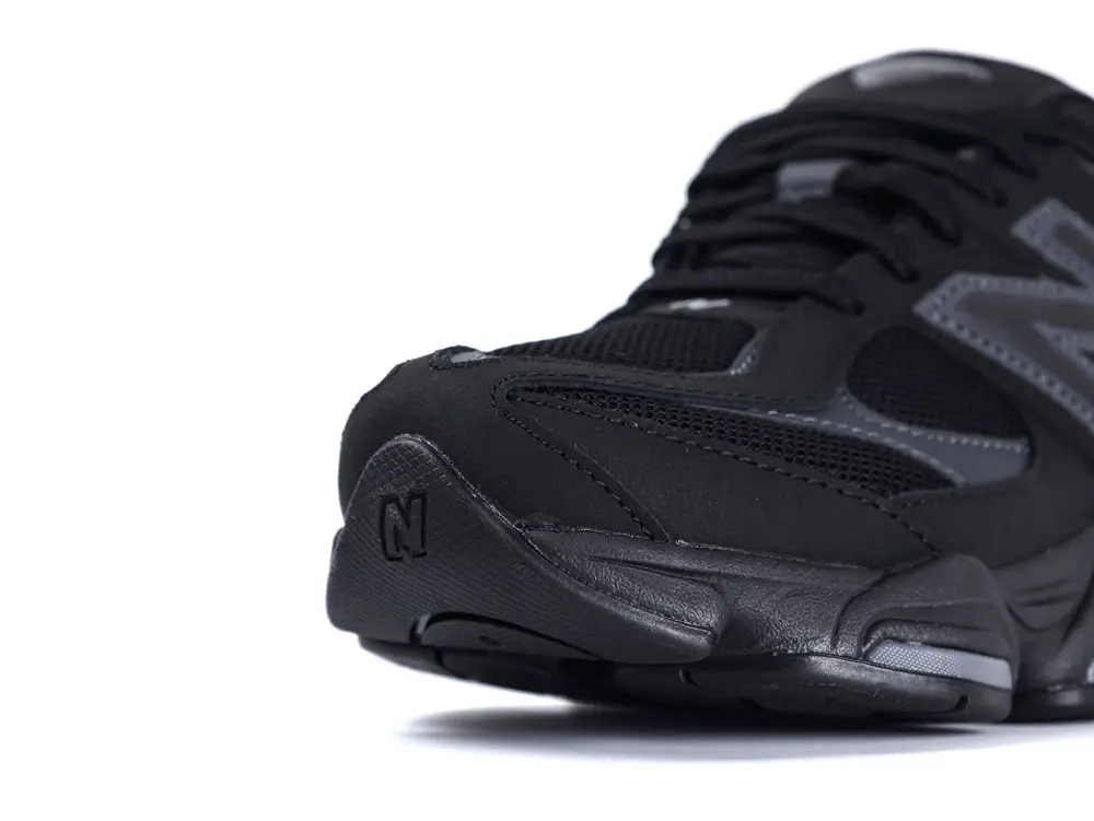 Black mesh and leather sneakers featuring chunky sole and side logo detail.