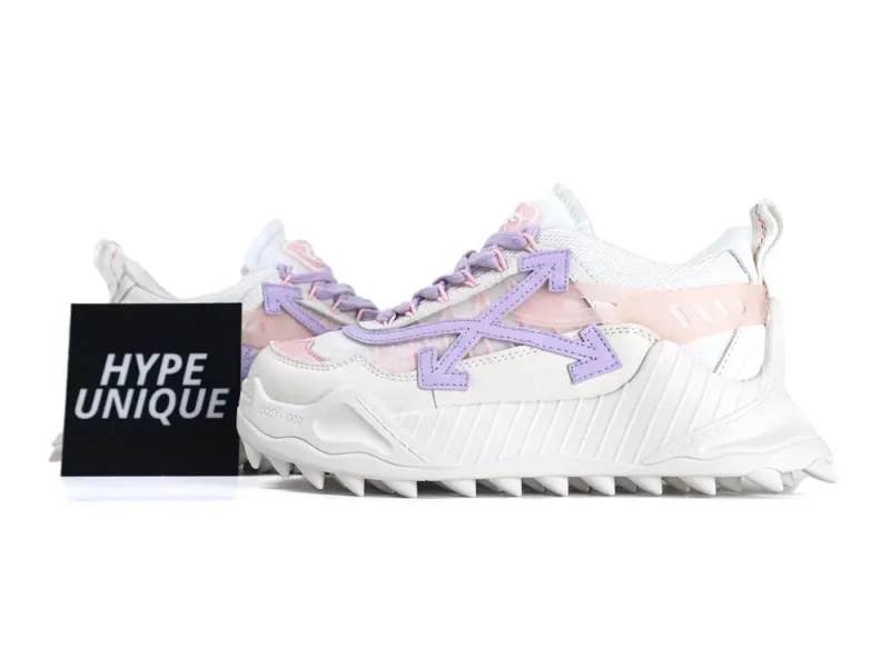 White sneakers with pink and purple accents, textured leather material, spiked rubber sole.