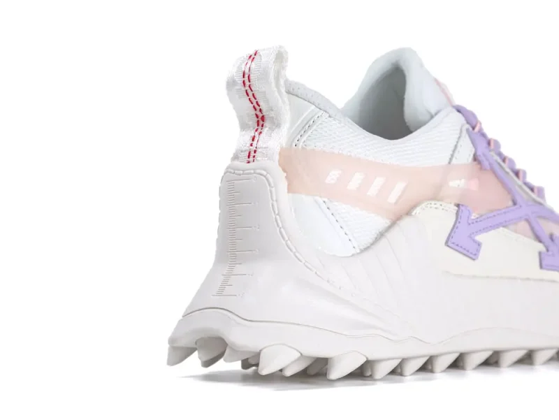White and pastel-colored sneaker with mesh material and textured rubber sole.