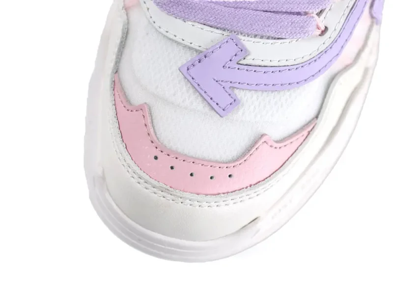 Close-up of a sneaker showing purple and pink leather accents on the toe.