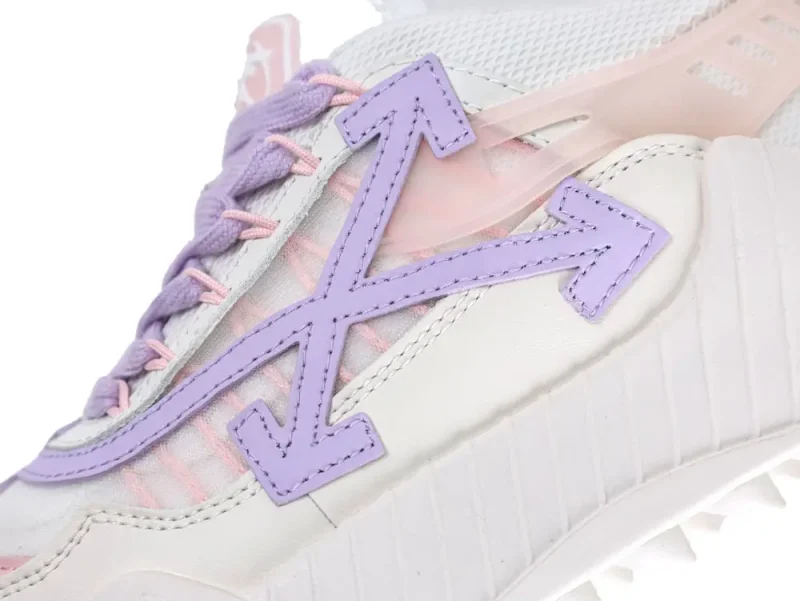 Close-up of a white sneaker with lavender accents and pink laces.