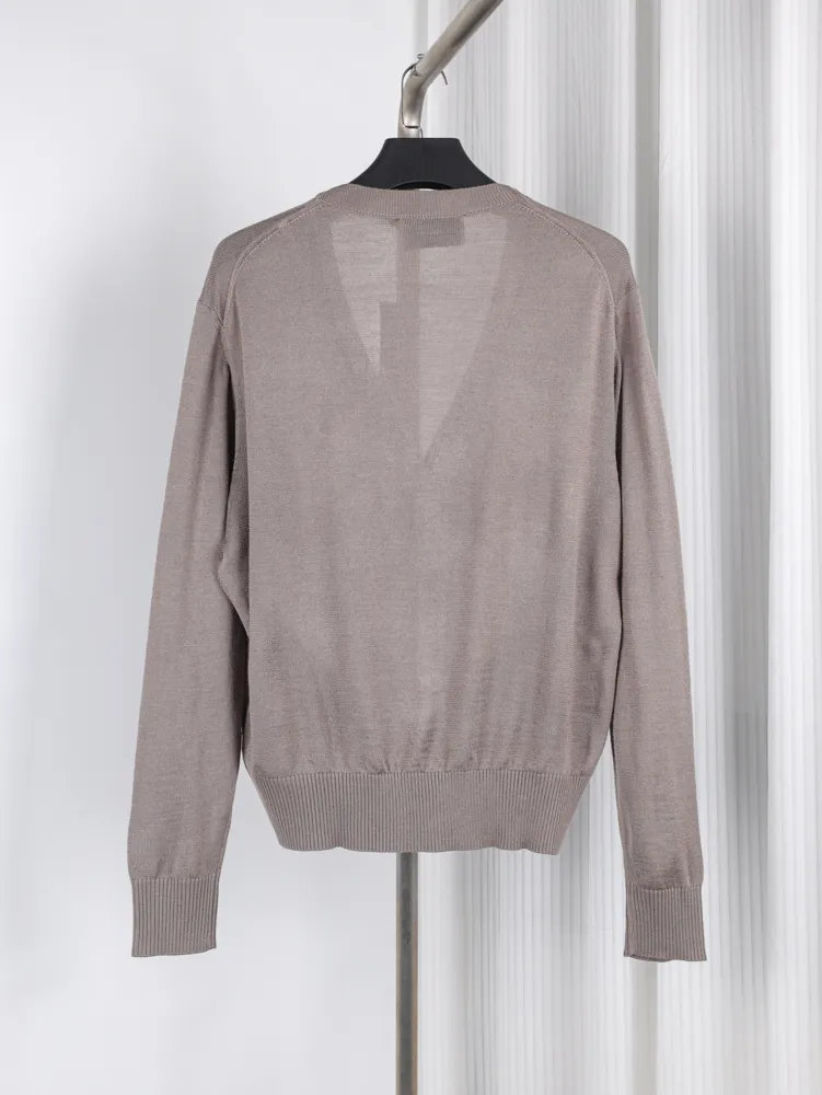Taupe knit sweater with ribbed cuffs and hem, displayed on a hanger.