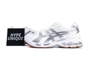 White and silver sneakers with mesh upper and rubber sole, side branding visible.