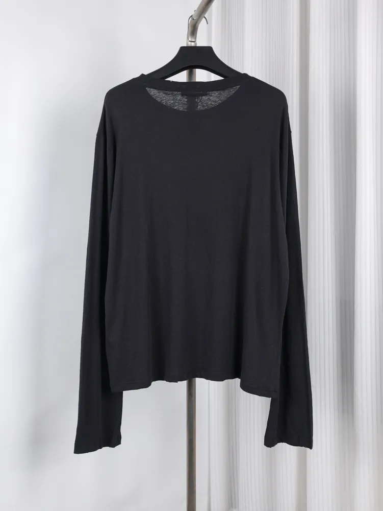 Black cotton long-sleeve shirt on hanger, showcasing soft fabric and relaxed fit.