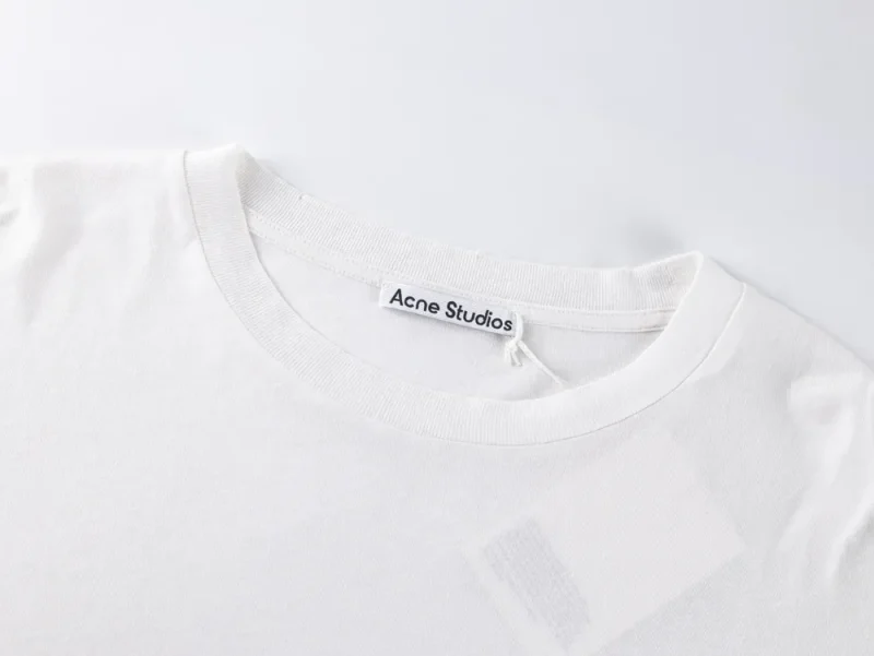 White cotton t-shirt, close-up of the neckline and label area.
