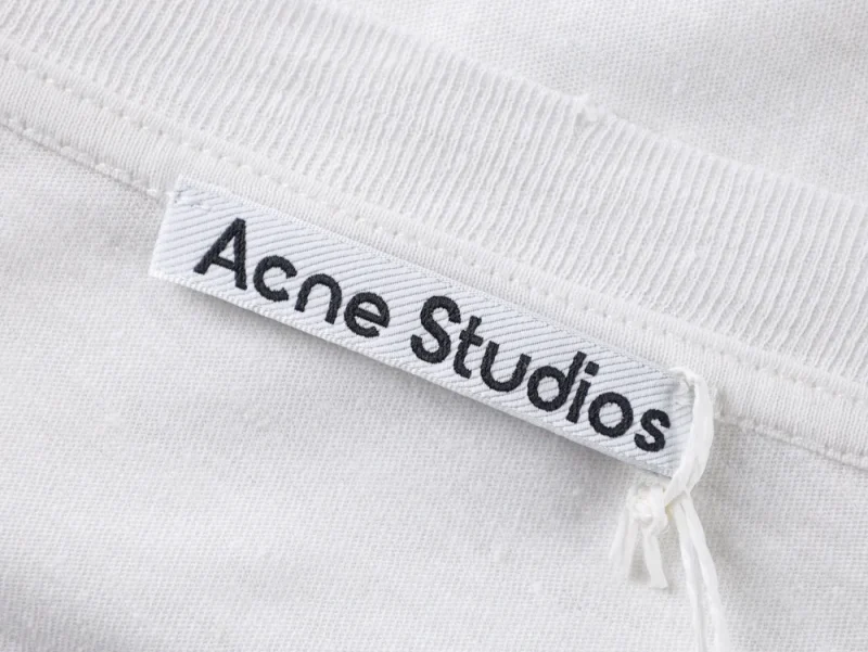 White cotton clothing tag with Acne Studios