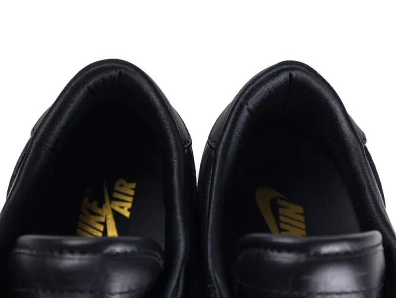 Close-up of black leather shoes with visible insoles and yellow Nike Air logo.