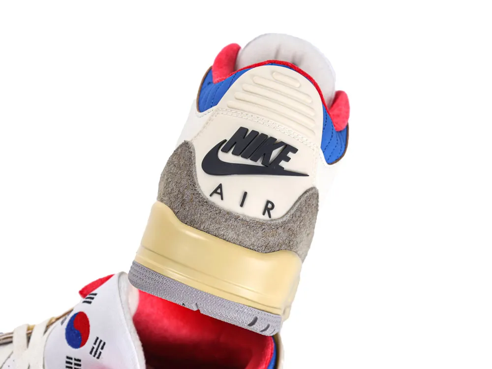 Cream and blue sneaker with suede accents and visible sole branding.