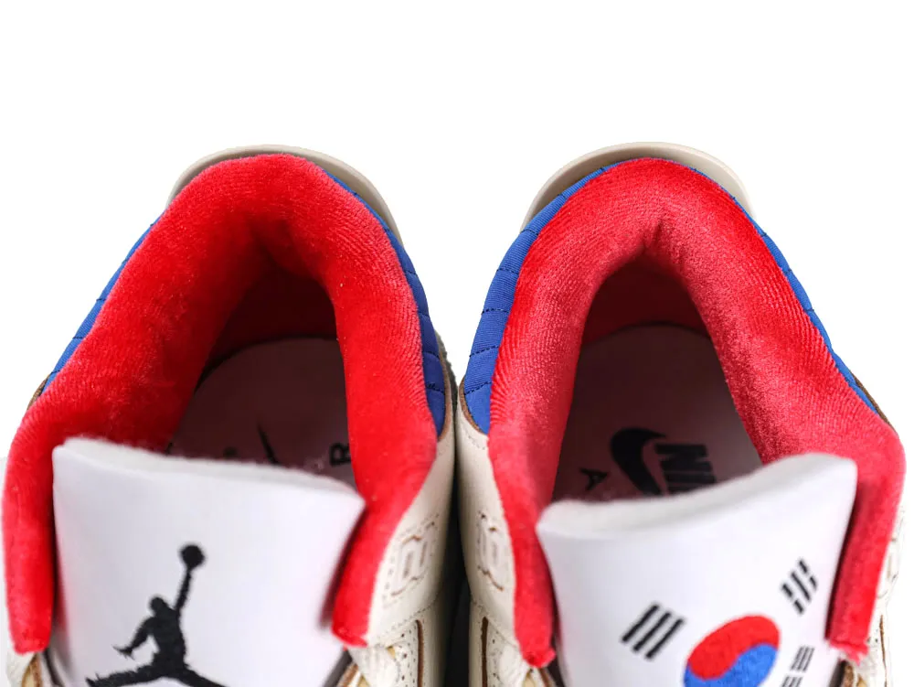 Sneaker heels with red interior lining, white leather exterior, and blue accents.