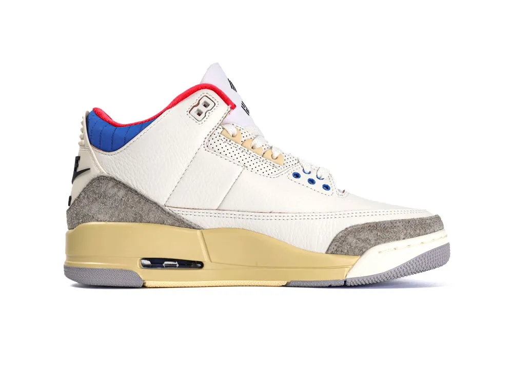 White leather sneakers with blue, red accents, grey suede detail, and beige sole.