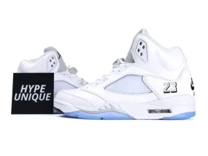 White leather sneakers with mesh panel and translucent blue sole, featuring embroidered details.