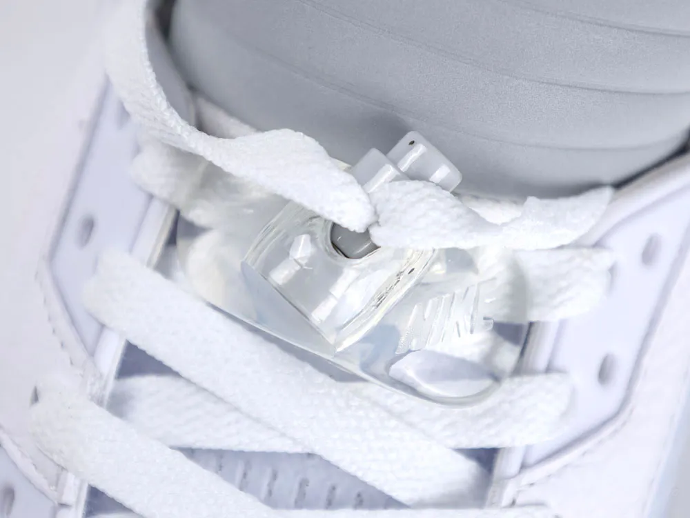 White shoelaces with a transparent plastic lace lock on a gray sneaker.