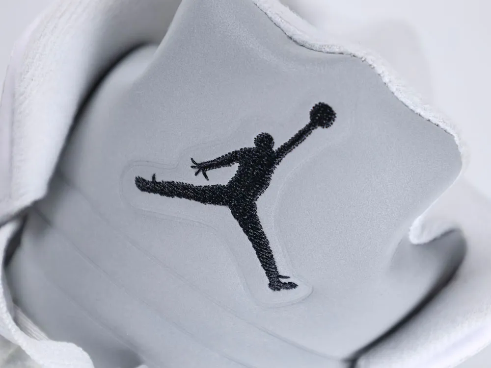 Gray leather sneaker tongue with black embroidered logo, featuring white fabric edges.