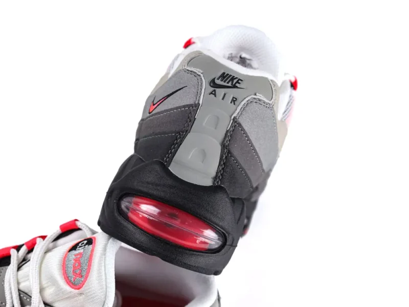 Gray and black sneaker with red accents, featuring an air cushion heel.