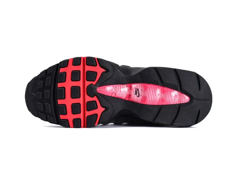 Black rubber shoe sole with red accents and pink transparent cushioning section.