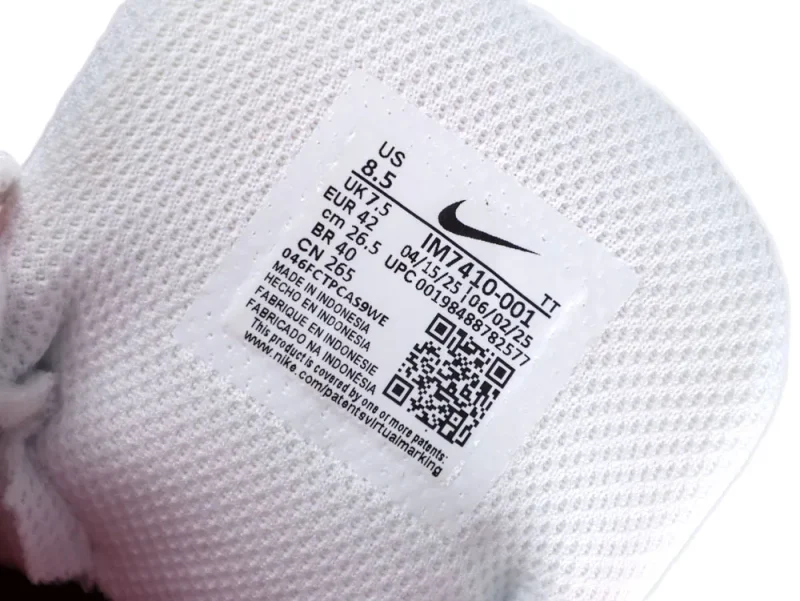 White knitted fabric with product label and QR code from a shoe interior.