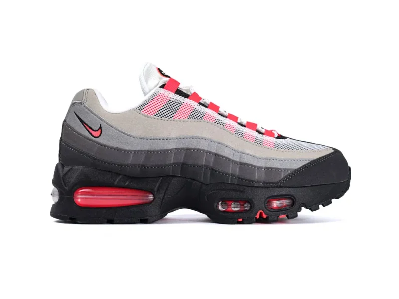 Gray, black, and red sneaker with mesh upper and rubber sole.