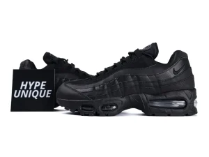 Black sneakers featuring mesh and leather materials with visible air cushioning in the sole.