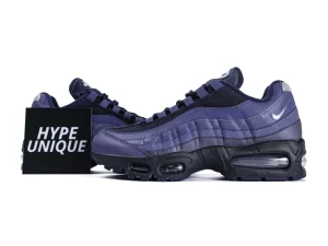 Dark purple mesh and leather sneakers with black sole and visible air cushioning.
