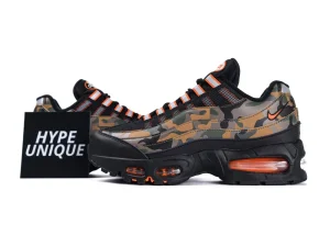 Camo-patterned sneakers with black mesh material and orange accents on the sole.