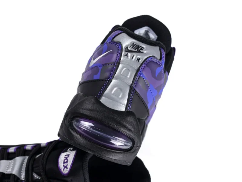 Purple and silver sneaker with black accents, featuring an air cushioning sole.