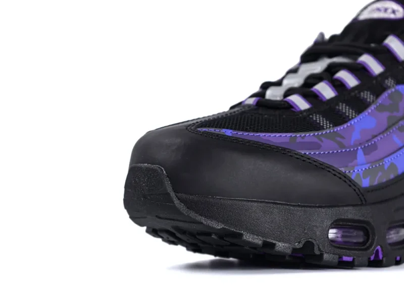 Black and purple sneaker with camouflage design and mesh detailing on the upper.