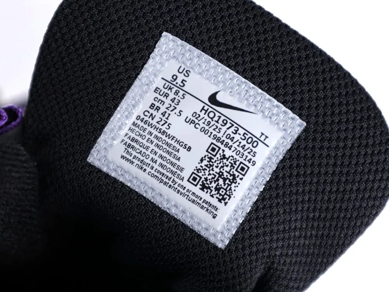 Black fabric sneaker tongue with white label, displaying size and manufacturing details.
