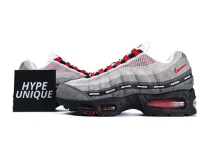 Gray and red sneakers with suede and mesh upper, black rubber sole.