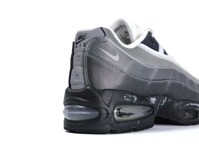 Gray and black sneaker with mesh upper and visible air cushioning sole.
