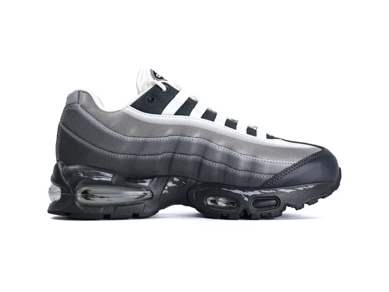 Gray sneakers with mesh panels and black leather accents on the sole.