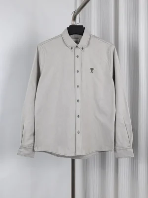 Button-down collar, featuring Heart embroidered logo on chest.