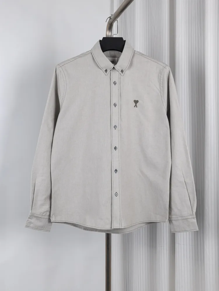 Button-down collar, featuring Heart embroidered logo on chest.